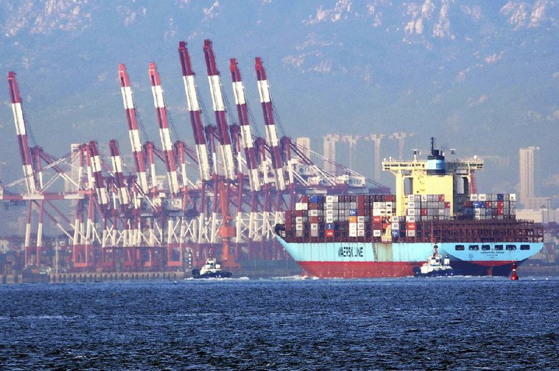 Tugboats move a container ship to a dockyard in Qingdao, China, earlier this week. 