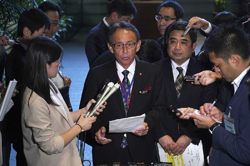 “I want to appeal to America” about Okinawans’ desire to move the U.S. Marine base off the island, Okinawa Gov. Denny Tamaki (center) said Friday after meeting with Japanese Prime Minister Shinzo Abe. 