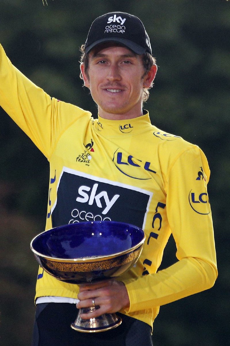 Tour de France winner Geraint Thomas of Britain celebrates on the podium July 29 in Paris. Team Sky said in a statement Wednesday that police are investigating after the champion’s trophy disappeared during an event organized in Birmingham, where the team displayed the trophies won by its riders. 