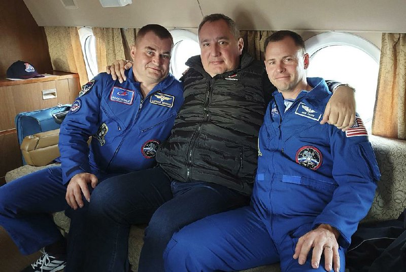 Dmitry Rogozin (center), the head of Russian space agency Roscosmos, sits with cosmonaut Alexei Ovchinin (left) and U.S. astronaut Nick Hague at Star City, Russia, in an undated photo. Rogozin promised that Ovchinin and Hague will get another chance to go to space after Thursday’s aborted launch. 