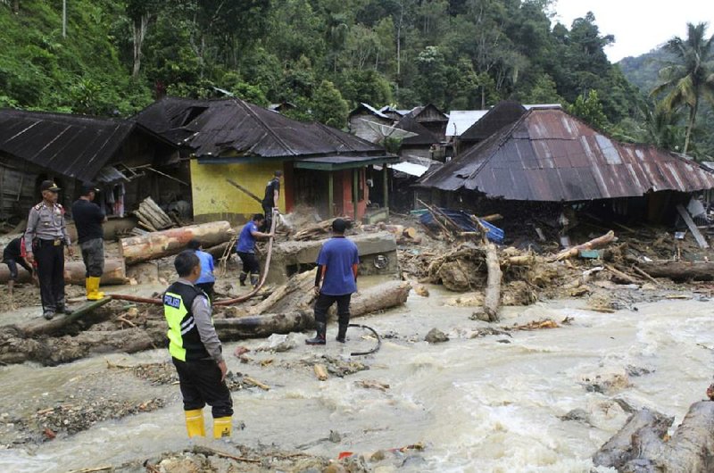 Rescuers search for victims Saturday after a flash flood in the Mandailing Natal district of Indonesia’s Sumatra island. 