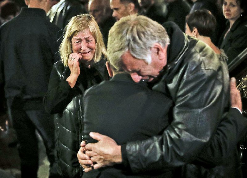 A woman identified as the mother of slain television journalist Viktoria Marinova mourns among others during a service before her daughter’s funeral Friday in Ruse, Bulgaria.