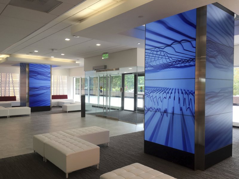 This Oct. 2, 2018, photo shows the renovated interior of the former General Electric headquarters in Fairfield, Conn., which was purchased by Sacred Heart University in 2016. Office parks sitting vacant on the edges of cities around the U.S. have repurposed as schools by a number of urban and suburban districts due to growing enrollment, a scarcity of available land and evolving ideas about the elements required for a school building. (AP Photo/Mike Melia)