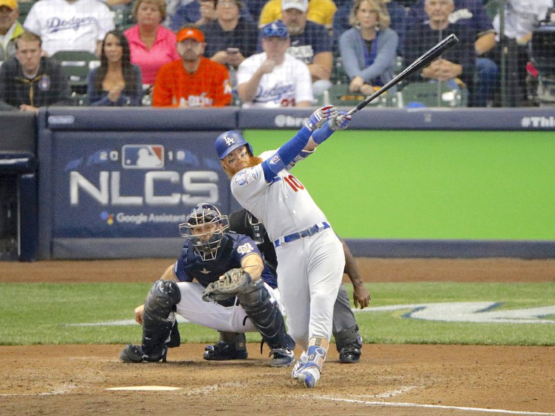 Los Angeles Dodgers' Justin Turner (10) hits a two-run home run during the eighth inning of Game 2 of the National League Championship Series baseball game against the Milwaukee Brewers Saturday, Oct. 13, 2018, in Milwaukee. (AP Photo/Charlie Riedel)