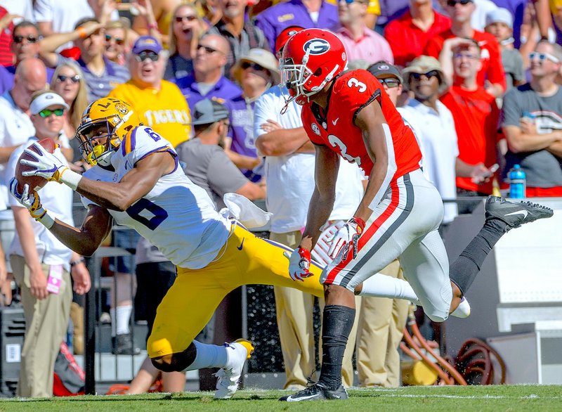 LSU wide receiver Terrace Marshall Jr. (6) makes a reception against Georgia defensive back Tyson Campbell (3) in the first half of an NCAA college football in Baton Rouge, La., Saturday, Oct. 13, 2018. (AP Photo/Matthew Hinton)