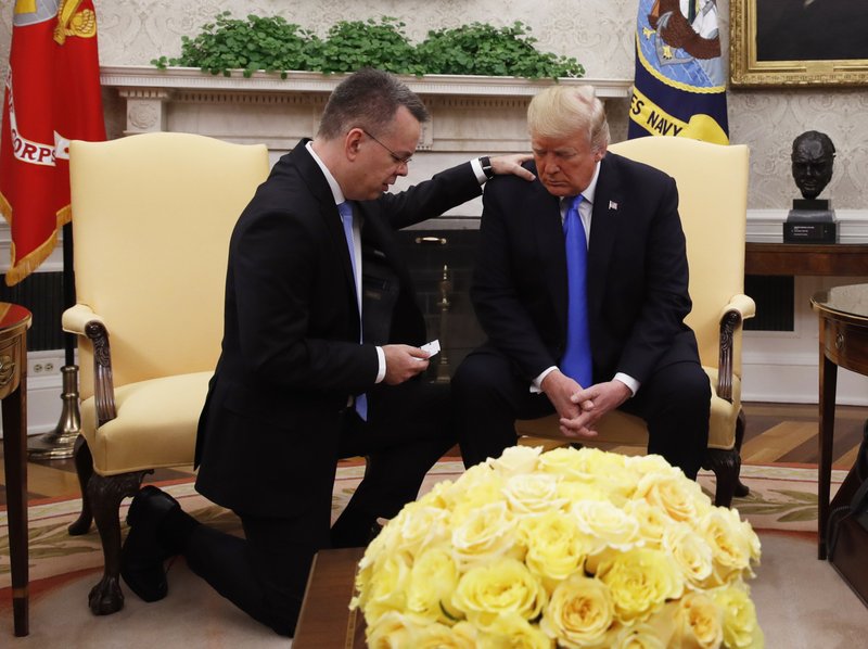 President Donald Trump prays with American pastor Andrew Brunson in the Oval Office of the White House, Saturday October 13, 2018, in Washington. Brunson returned to the U.S. around midday after he was freed Friday, from nearly two years of detention in Turkey. (AP Photo/Jacquelyn Martin)