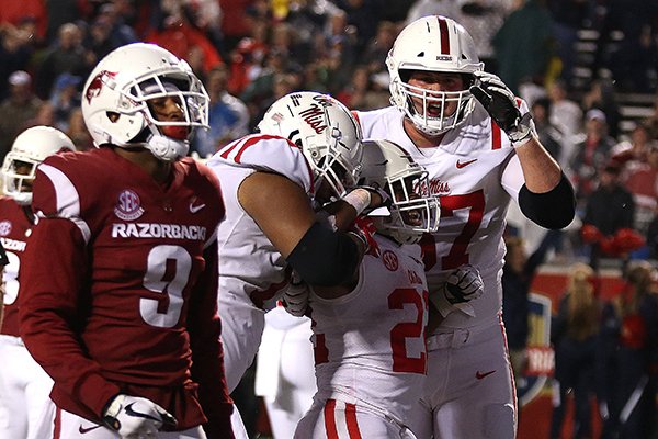 Ole Miss running back Scottie Phillips (22) celebrates with teammates after scoring on a 5-yard touchdown in the fourth quarter of Ole Miss' 37-33 win over Arkansas on Saturday, Oct. 13, 2018, at War Memorial Stadium in Little Rock.