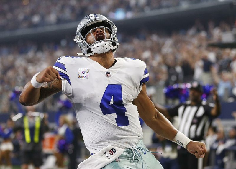 Dallas Cowboys quarterback Dak Prescott (4) celebrates after a touchdown in the first half Sunday against the Jacksonville Jaguars in Arlington, Texas. Prescott threw two touchdown passes to Cole Beasley and rushed for a career-high 82 yards with another score in the Cowboys’ 40-7 victory.