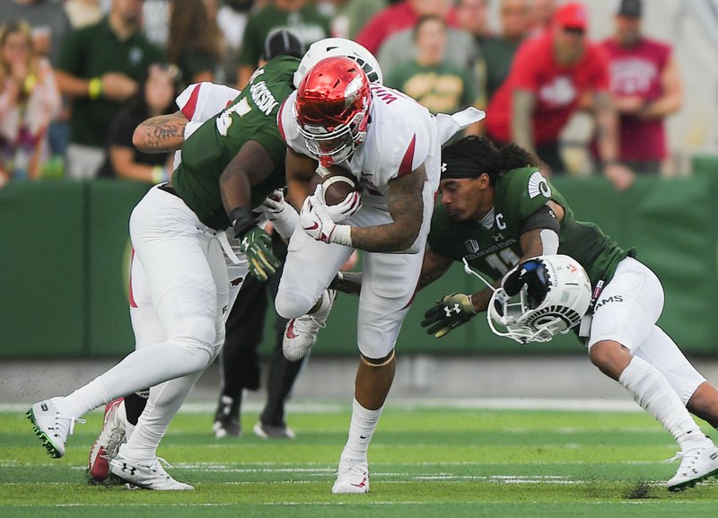 NWA Democrat-Gazette/CHARLIE KAIJO Colorado State Rams defenders tackle Arkansas Razorbacks running back Devwah Whaley (21) during the first quarter of a football game, Saturday, September 8, 2018 at Colorado State University in Fort Collins, Colo.