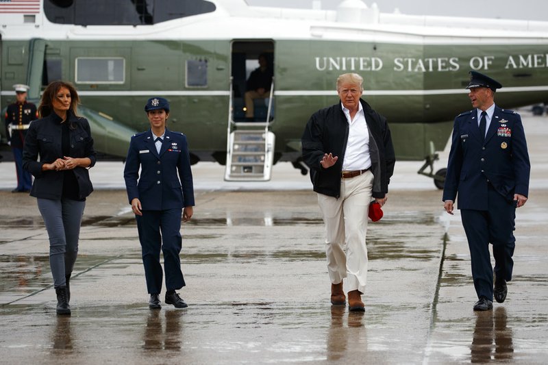 President Donald Trump and first lady Melania Trump board Air Force One for a trip to visit areas affected by Hurricane Michael on Monday, Oct. 15, 2018, in Andrews Air Force Base, Md.
