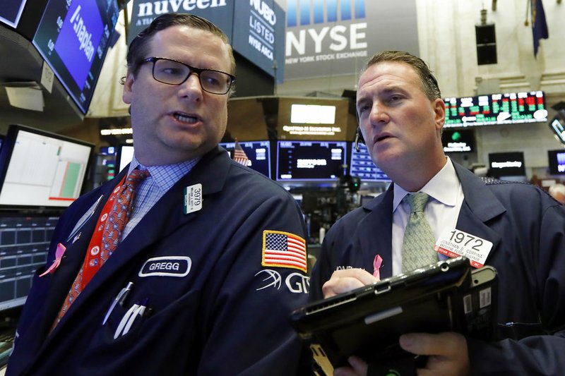 Specialist Gregg Maloney, left, and trader Jonathan Corpina work on the floor of the New York Stock Exchange, Monday, Oct. 15, 2018. Stocks are opening mostly lower as technology companies continue to fall. (AP Photo/Richard Drew)