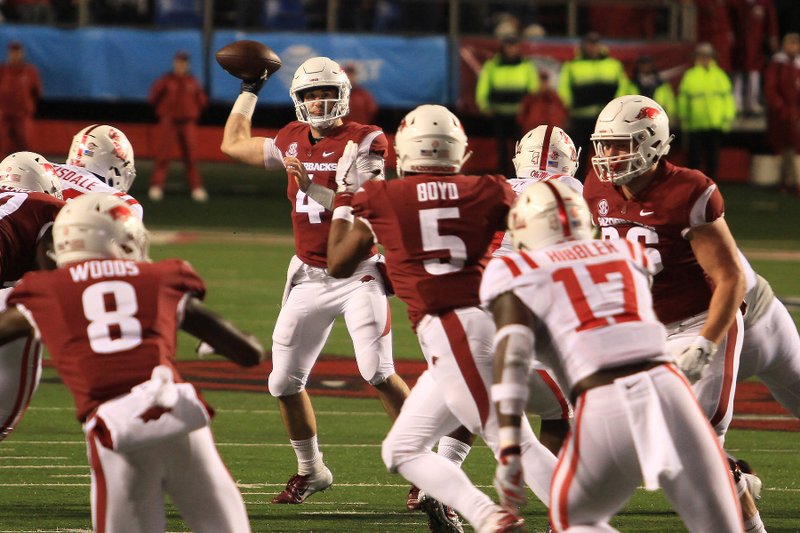 Arkansas quarterback Ty Storey looks to pass the ball against the Ole Miss defense. The Razorbacks fell to the Rebels in SEC action at War Memorial Stadium Saturday night.