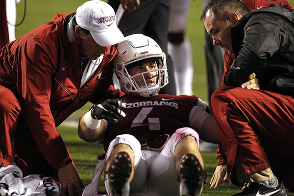 Arkansas quarterback Ty Storey (4) is tended to by trainers during the fourth quarter of the Razorbacks' 37-33 loss to Ole Miss on Saturday, Oct. 13, 2018, at War Memorial Stadium in Little Rock.