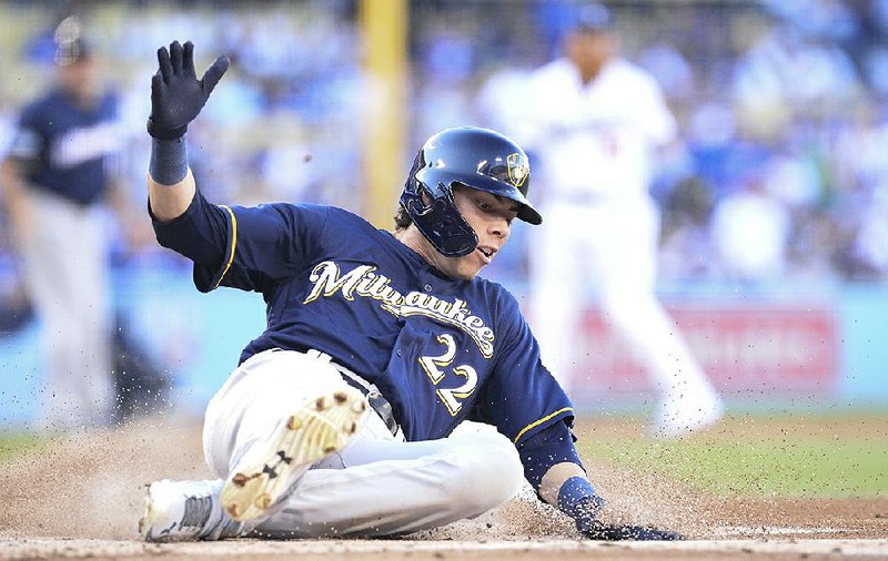 Christian Yelich of the Milwaukee Brewers scores during the first inning of Game 3 of the National League Championship Series against the Los Angeles Dodgers on Monday in Los Angeles. The Brewers won 4-0 to take a 2-1 series lead.