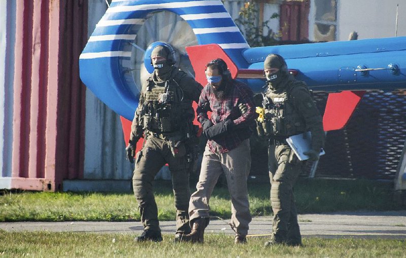 Authorities escort Mounir el Motassadeq from a helicopter Monday at the airport in Hamburg, Germany.