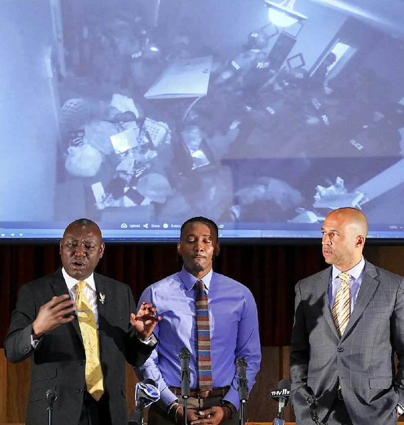 Attorney Ben Crump discusses a federal lawsuit on Monday that Roderick Talley (center) filed in 2017 complaining that Little Rock police violated his civil rights in executing a search warrant at his home. Video from security camera, arkansasonline.com/1016raid