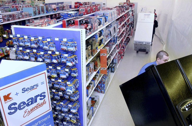 FILE - In this March 24, 2005, file photo Kenmore refrigerators are wheeled into the existing K-Mart in Nashua, N.H., to become a &quot;Sears Essentials&quot; store. Sears has filed for Chapter 11 bankruptcy protection Monday, Oct. 15, 2018, buckling under its massive debt load and staggering losses. The company once dominated the American landscape, but whether a smaller Sears can be viable remains in question. (AP Photo/Jim Cole, File)