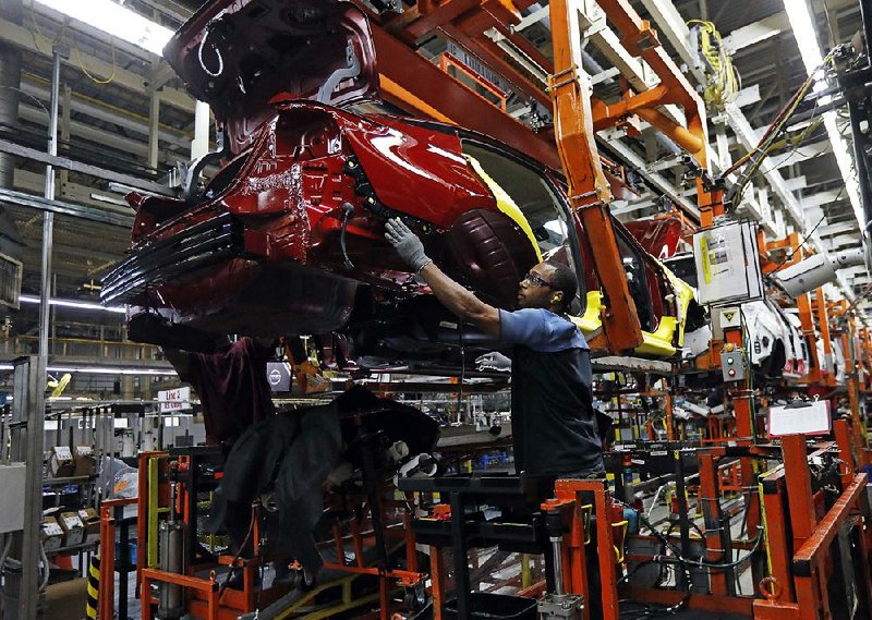 Workers assemble a redesigned Altima sedan in September at the Nissan plant in Canton, Miss. Autos led the 0.2 percent rise in the production of consumer goods in September. 