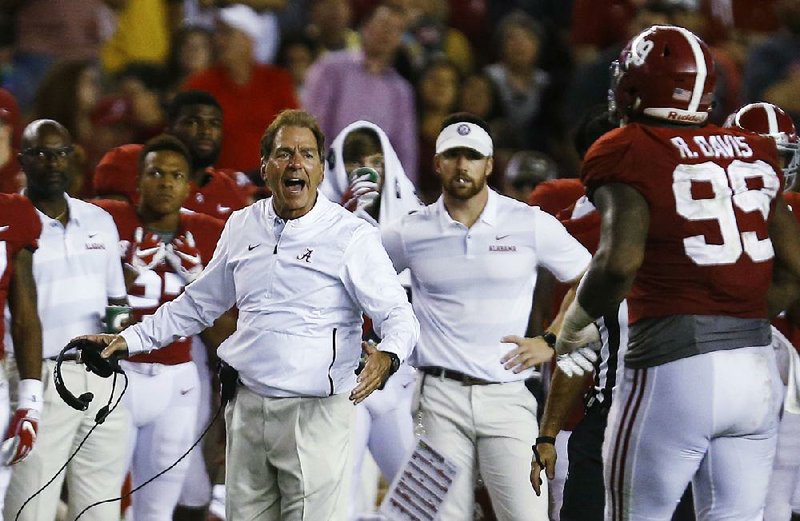 Coach Nick Saban (left) and the Alabama Crimson Tide are once again the class of college football, outscoring opponents 375-106 on the way to a 7-0 record so far this season. 
