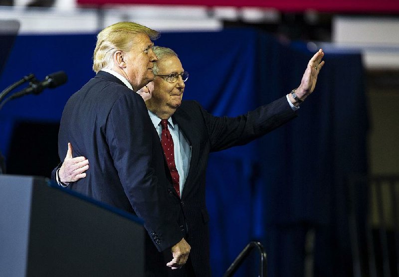 Senate Majority Leader Mitch McConnell and President Donald Trump attend a rally Saturday in Richmond,Ky. McConnell said Tuesday that “entitlement changes” were “the real driver” of the rising budget deficit and could only be contained if the Democrats controlled at least one chamber of Congress. 