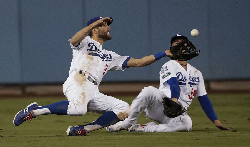 Chris Taylor of the Los Angeles Dodgers makes a diving catch on a ball hit by Orlando Arcia of the Milwaukee Brewers during the seventh inning of Game 4 of the National League Championship Series on Tuesday night. 