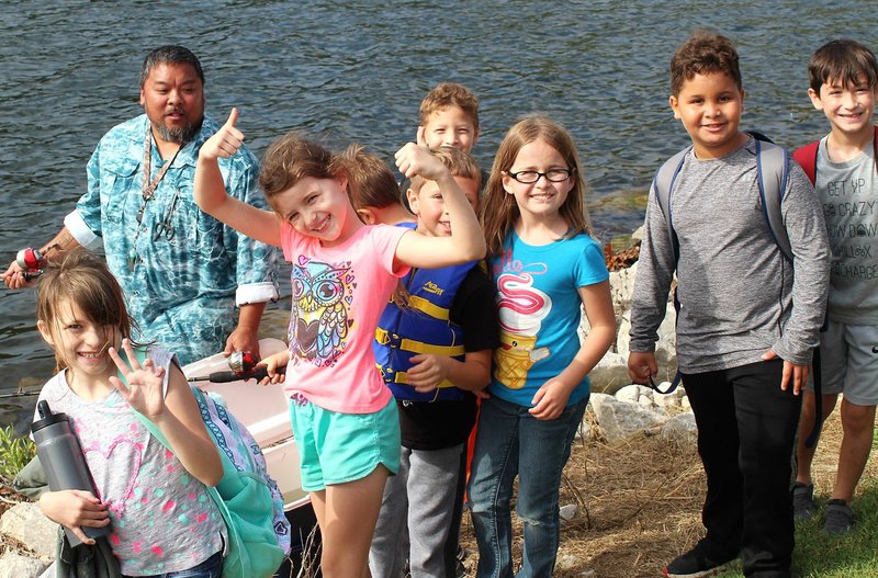 Photo submitted Shown are just a few of the approximately 100 third grade students and staff from Baker Elementary, who were thrilled with the prospect of learning how to catch fish while on an outing at Lake Windsor in Bella Vista with the Fly Tyers club.