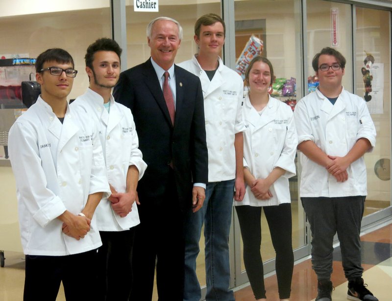 Westside Eagle Observer/SUSAN HOLLAND Governor Asa Hutchinson poses with members of the culinary arts class at Gravette High School who prepared the meal for the annual Lincoln/Reagan Day Dinner Tuesday, Oct. 9. Pictured are Drake Short (left), Wesley Hearne, Governor Hutchinson, Benny Rambadt, Hannah Dunlap and Byron Phillips.