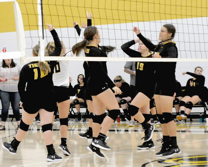 MARK HUMPHREY ENTERPRISE-LEADER/Prairie Grove players celebrate an ace during the Lady Tigers' four-set (22-25, 25-20, 25-22, 25-23) match win over Gravette on Tuesday, Oct. 9, 2018.