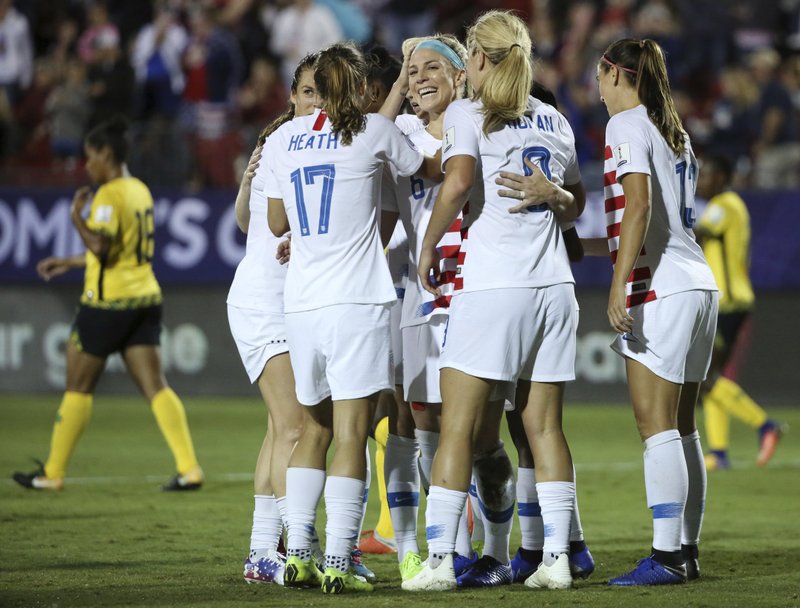 The Associated Press DOWN TO CANADA: Teammates celebrate after United States midfielder Julie Ertz (center) scored a goal Sunday during the first half the team's 6-0 win in Frisco, Texas, to qualify for the Women's World Cup and set up a final against Canada.
