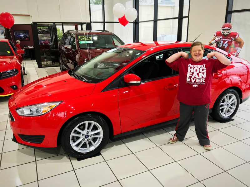 Fletcher Auto Group in Sherwood surprised Razorback superfan Canaan Sandy and his mother, Ginger Sandy, with a new car Tuesday. 