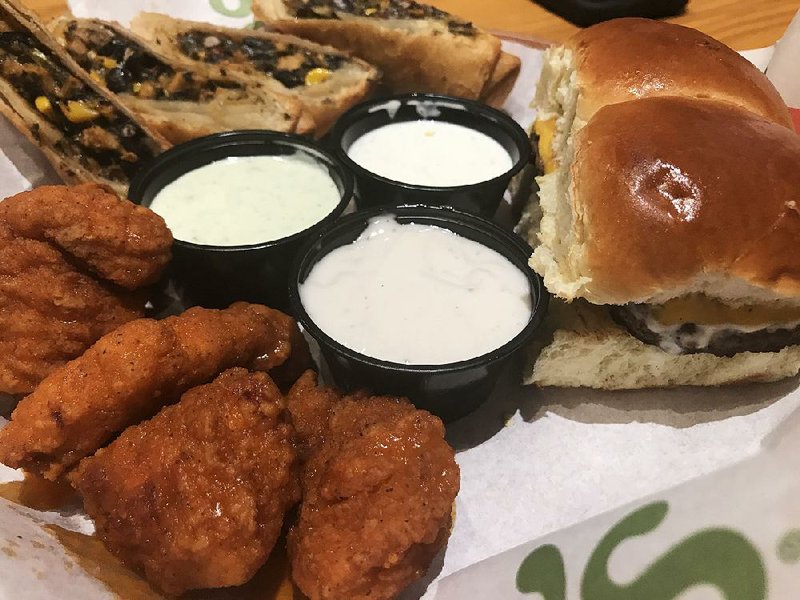 A Triple Dipper appetizer sampler features Southwestern Eggrolls, Boneless Buffalo Wings, Big Mouth Bites and dipping sauces at Chili’s in west Little Rock.