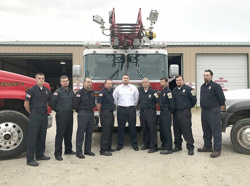 Sally Carroll/McDonald County Press The brotherhood at the Noel Fire Department keeps volunteers motivated to help each other and the community. The crew includes Blake Barrett (left), Tony Sideravage, Anthony Ortega, Eric Bennett, Captain Shain Scott, Ray Powell, Cody Miller, Jeff Whitehill and Michael Patton. Not pictured is Chief Brandon Barrett.