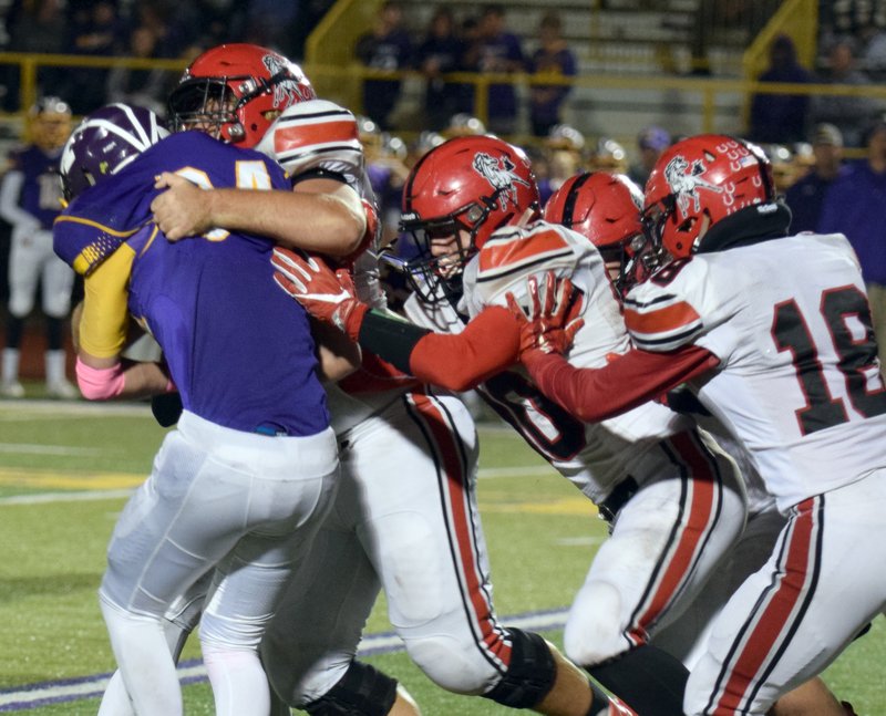 RICK PECK/SPECIAL TO MCDONALD COUNTY PRESS McDonald County defensive lineman Elliott Wolfe along with Micah Burkholder (80), Joe Brown (18) and others stop Monett's William Murphy for a short gain during the Cubs 18-12 win on Friday night at Monett High School.