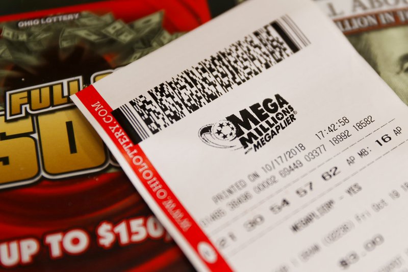 A Mega Millions lottery ticket rests on the shop counter at the Street Corner Market on Wednesday, Oct. 17, 2018, in Cincinnati. 