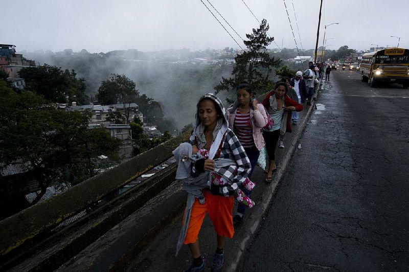 Hondurans leave Guatemala City at sunrise Thursday as their caravan resumes the trek northward toward the United States. 