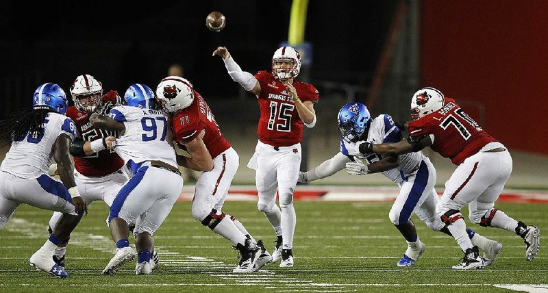 Arkansas State quarterback Justice Hansen (center) gets off a pass under pressure during the Red Wolves’ victory over Georgia State on Thursday night at Centennial Bank Stadium in Jonesboro. Hansen threw for three touchdowns and rushed for two in the victory.