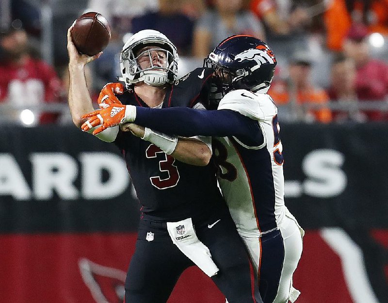 Arizona Cardinals quarterback Josh Rosen (3) passes as he is hit by Denver Broncos linebacker Von Miller during Thursday night’s game in Glendale, Ariz. 