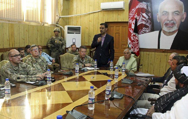 The head of NATO troops in Afghanistan, Gen. Scott Miller (center, left), Kandahar Gov. Zalmai Wesa (center, right) and their delegations attend a security conference Thursday in Kandahar, Afghanistan, before a gunman opened fire, killing Wesa and two other officials. 