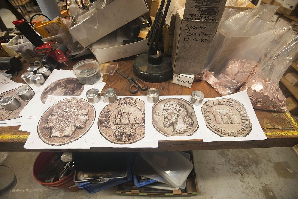 Hand engraved dies created from original artwork are displayed at the Shire Post Mint in Springdale. 