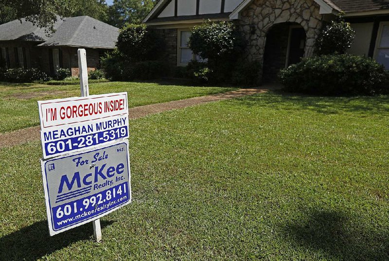 Long-term mortgage rates fell this week, but are still squeezing some buyers out of the market for homes like this one for sale in September in Jackson, Miss. 