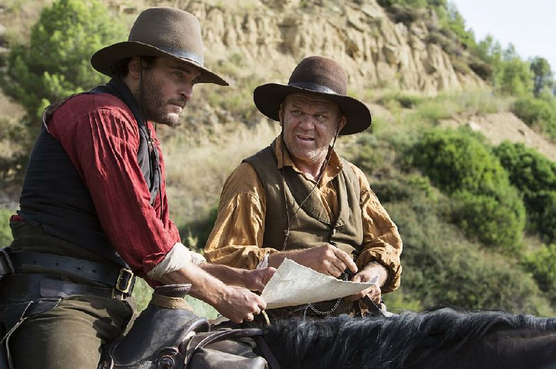 Charlie (Joaquin Phoenix) and Eli (John C. Reilly) are mercenaries who have second and third thoughts in Jacques Audiard’s offbeat Western, The Sisters Brothers.
