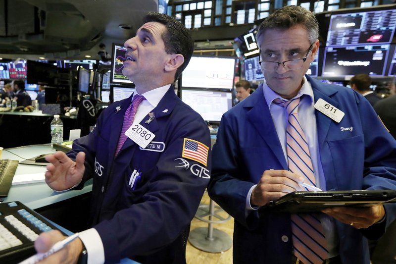 In this Oct. 11, 2018, file photo trader Peter Mazza, left, works with trader Daniel Trimble on the floor of the New York Stock Exchange. The U.S. stock market opens at 9:30 a.m. EDT on Thursday, Oct. 18. (AP Photo/Richard Drew, File)