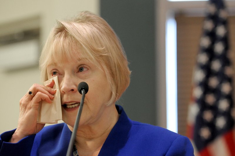 NWA Democrat-Gazette/DAVID GOTTSCHALK Toni Boone, John T. Hussey's widow, wipes away a tear Thursday while speaking during the Springdale Officer John T. Hussey Memorial Highway dedication at Springdale's City Council chambers. Hussey was killed in the line of police duty in 1975. The new U.S. 612, the northern bypass of Springdale, was dedicated in honor of Hussey.