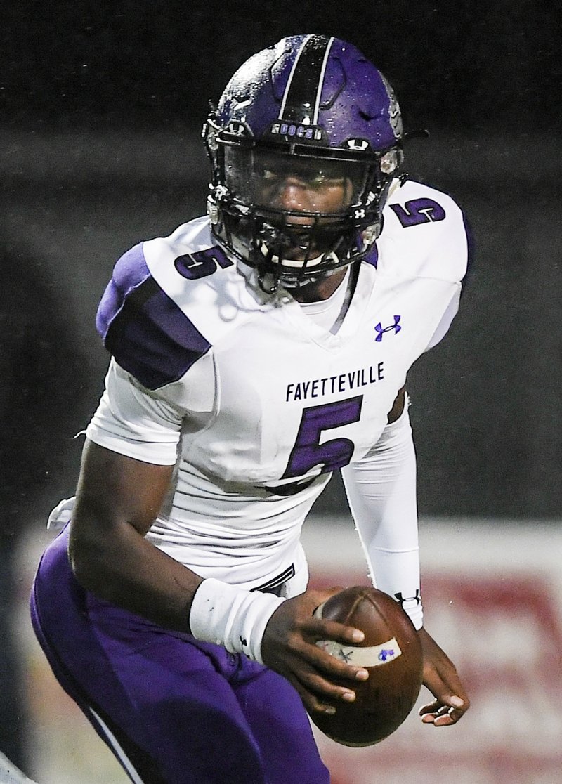 NWA Democrat-Gazette/CHARLIE KAIJO Fayetteville High School quarterback Darius Bowers (5) looks for a receiver during a football game, Friday, October 12, 2018 at Tiger Stadium in Bentonville High School in Bentonville.