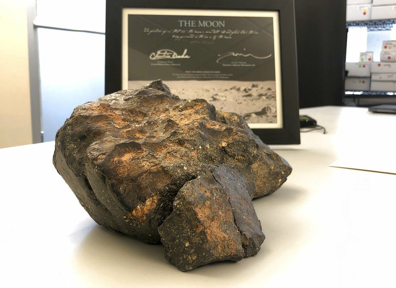 In this Oct. 10, 2018 file photo, a 12-pound lunar meteorite discovered in Northwest Africa in 2017 rests on a table in Amherst, N.H. 