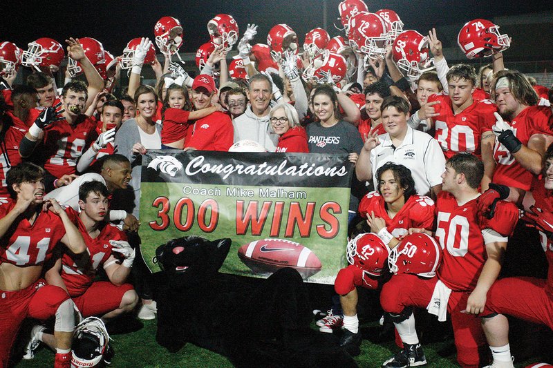 Cabot football coach Mike Malham, center, is surrounded by his family and players following the Panthers’ 41-21 win over Little Rock Central on Oct. 12 at Panther Stadium. The win was Malham’s 300th of his career, allowing him to join former Barton coach Frank McClellan, the only other high school coach in Arkansas to win at least 300 games.