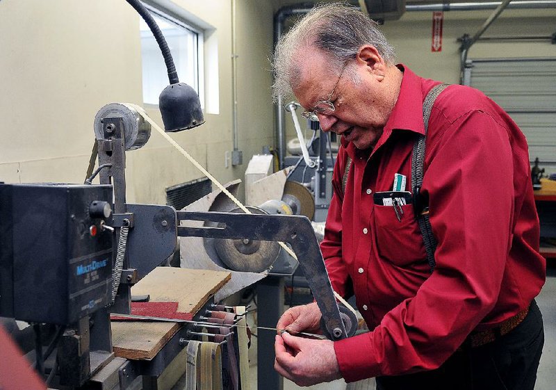 A.G. Russell, shown demonstrating a belt grinder in 2009 at the A.G. Russell Knives facility in Rogers, started his company in 1964 and was a founding member and honorary president of the Knifemakers Guild.