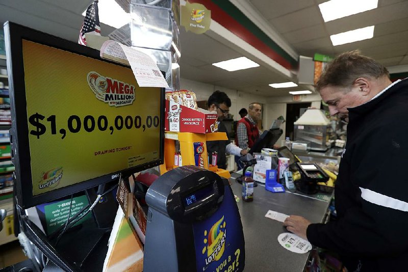 A sign displays the estimated Mega Millions jackpot at a convenience store Friday in Chicago. Friday’s jackpot was the second-largest in U.S. lottery history. 