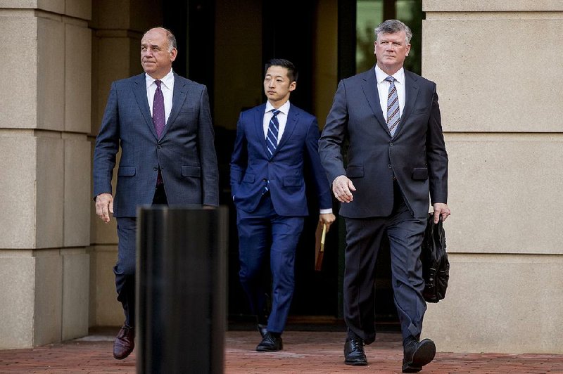 Members of Paul Manafort’s defense team, (from left) Thomas Zehnle, Tim Wang and Kevin Downing leave the federal court Friday after a hearing in the criminal case against their client. 
