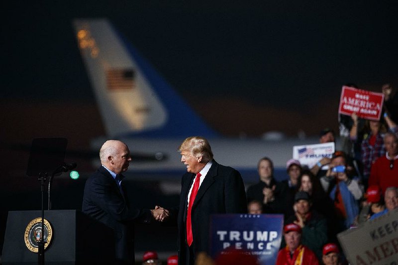 Rep. Greg Gianforte, R-Mont., and President Donald Trump shake hands during a Thursday campaign rally in Missoula, Mont. 